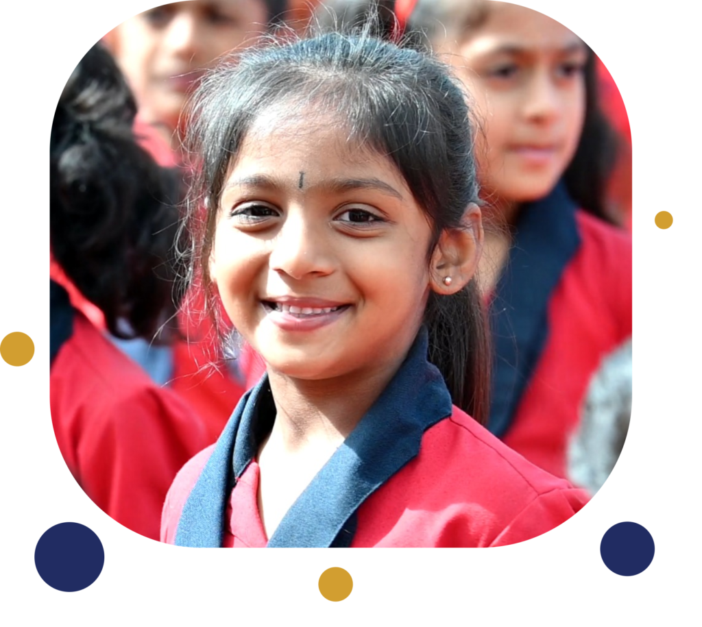 A cheerful schoolgirl from Pushpa English Medium School CBSE, Periya Patna, adorned in uniform, exudes genuine happiness with her radiant smile.