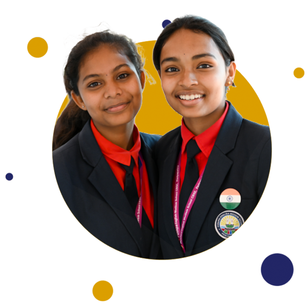 Side by side, stand two schoolgirls of Pushpa English Medium School CBSE, Periya Patna, their faces lit with radiant smiles that mirror the happiness they find in the school.